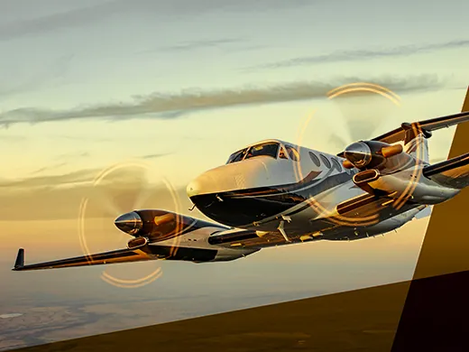 Private jet flying at sunset